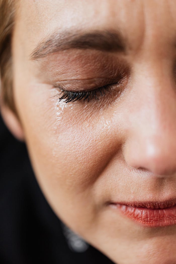 Home (DUPLICATE) Closeup of crop sad adult lady with natural makeup having problems and crying alone